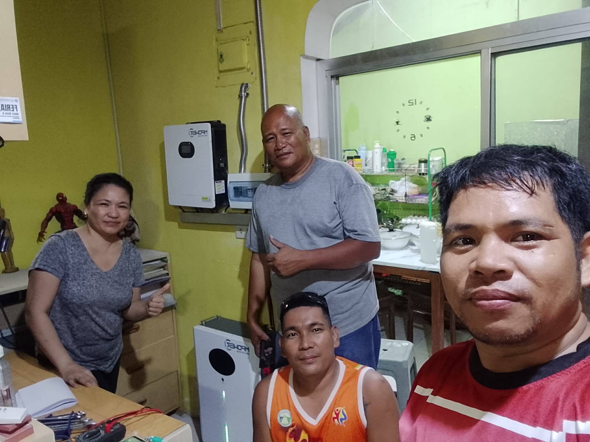 Ardyuron Solar team with happy clients beside their new hybrid solar power system